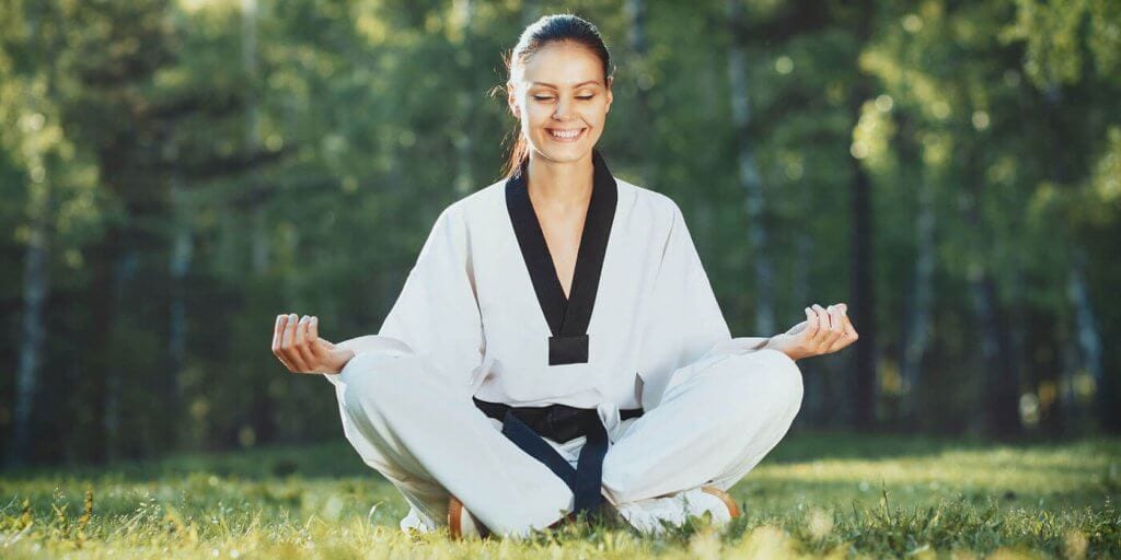 Martial Arts Lessons for Adults in Aurora IL - Happy Woman Meditated Sitting Background