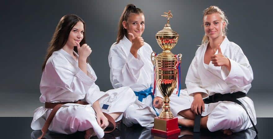 Martial Arts Lessons for Kids in Aurora IL - Thumbs Up and Trophies with Sitting Girls